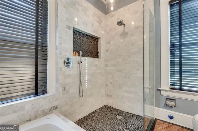 bathroom featuring plus walk in shower