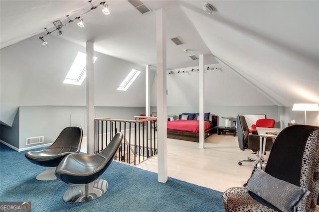 bedroom featuring light carpet and lofted ceiling with skylight