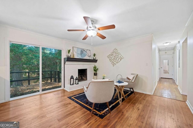 living area with ceiling fan, light hardwood / wood-style floors, and crown molding