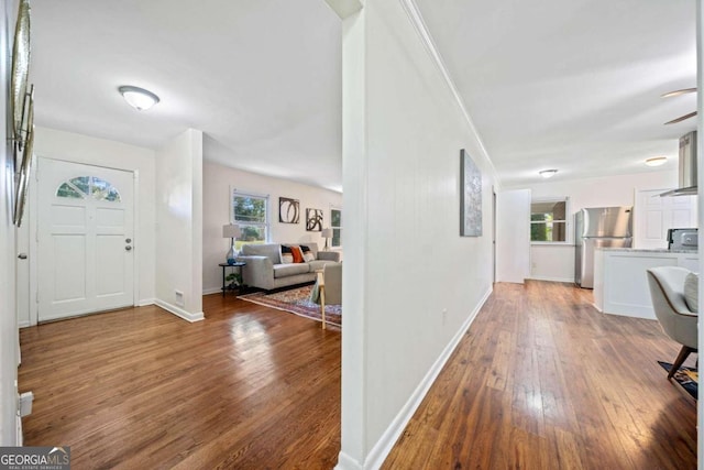 entryway with hardwood / wood-style floors and a healthy amount of sunlight