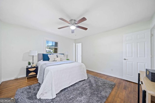 bedroom with ceiling fan and dark wood-type flooring