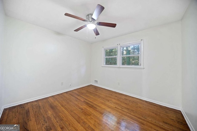 empty room featuring wood-type flooring and ceiling fan