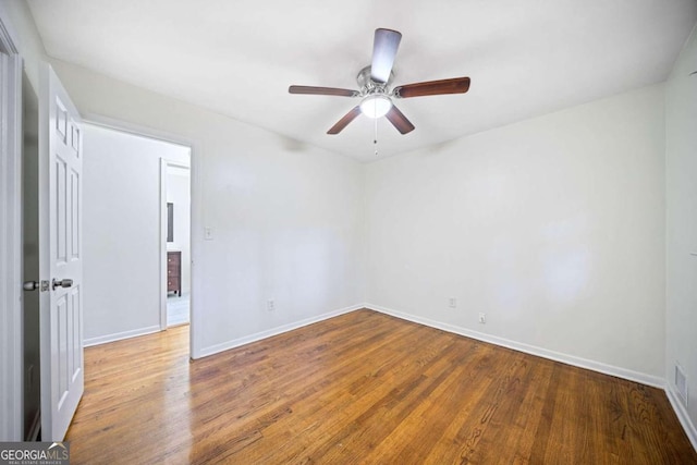 spare room with hardwood / wood-style flooring and ceiling fan