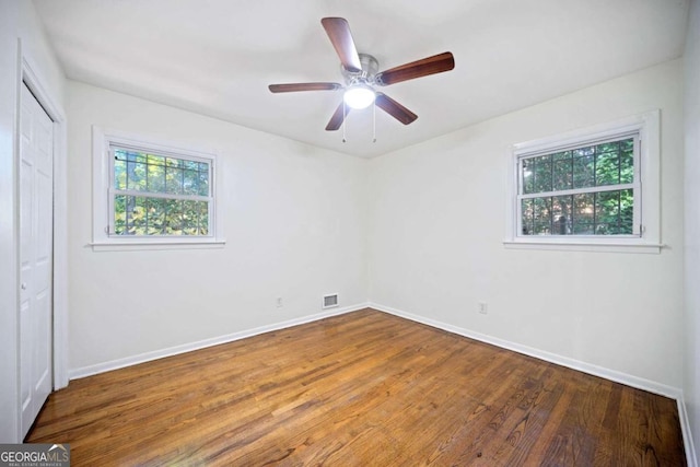 empty room featuring hardwood / wood-style flooring and ceiling fan