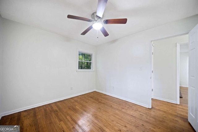 spare room with hardwood / wood-style flooring and ceiling fan