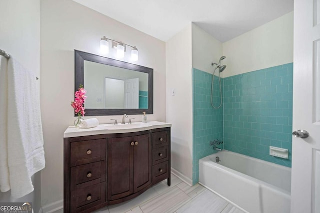 bathroom with vanity, tiled shower / bath combo, and tile patterned floors