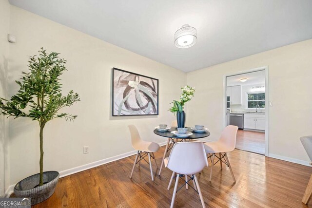 dining room featuring light hardwood / wood-style floors and sink