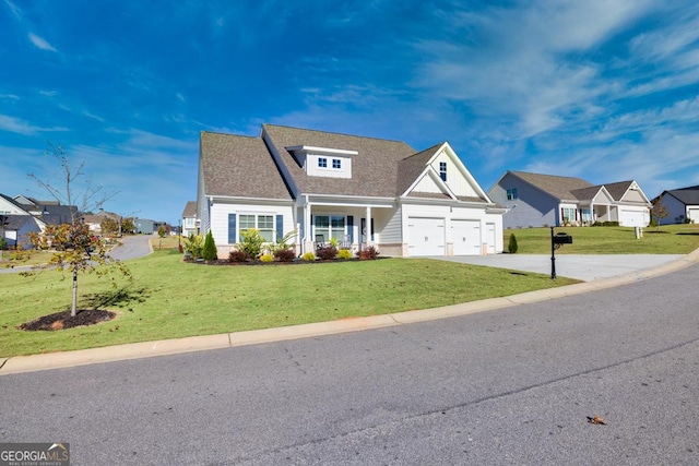 view of front of house with a porch, a garage, and a front lawn