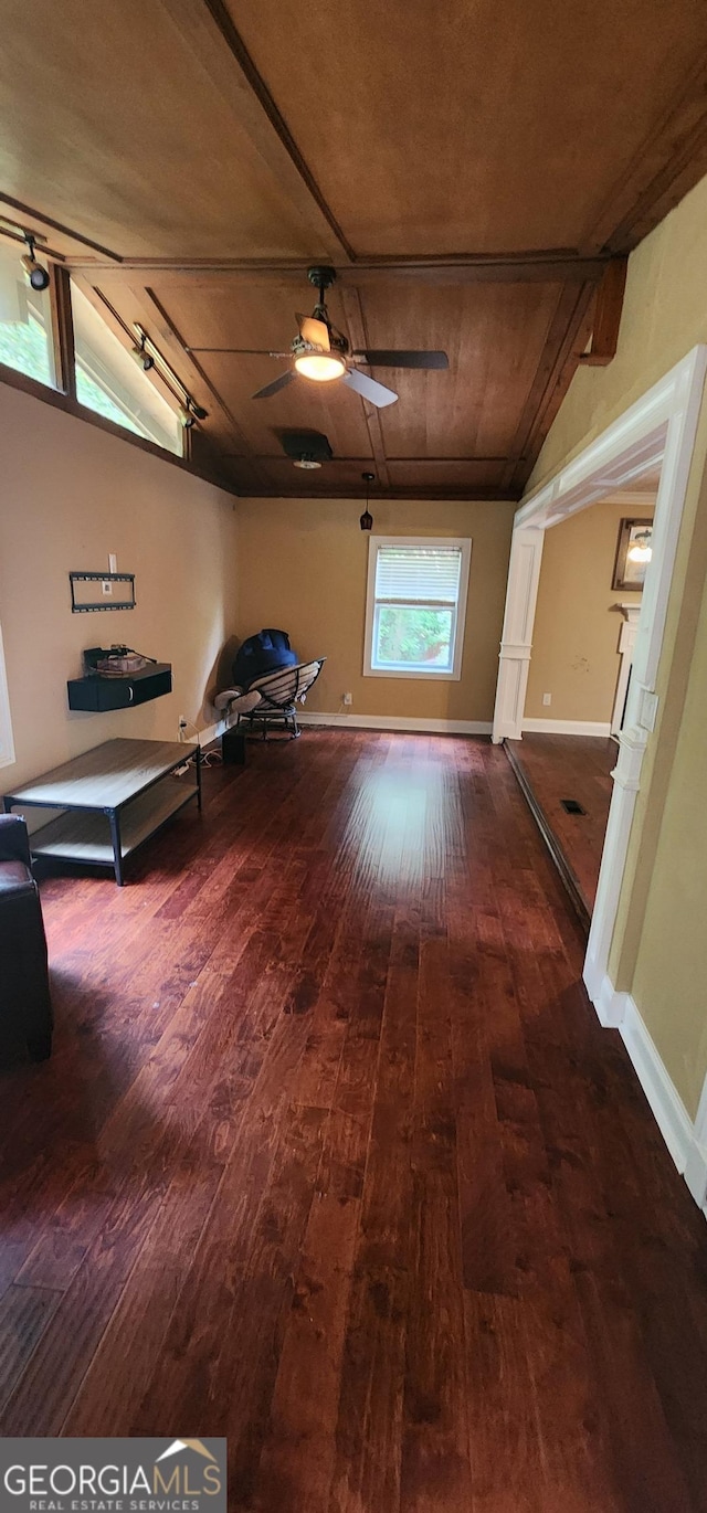 hallway featuring hardwood / wood-style floors, lofted ceiling, wood ceiling, and track lighting