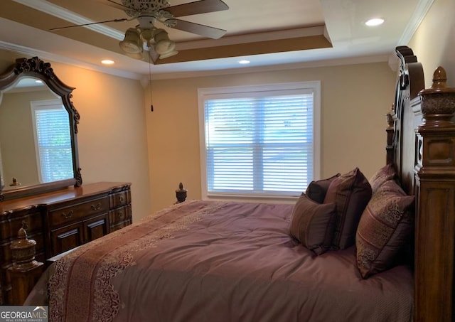 bedroom featuring a raised ceiling, ceiling fan, and crown molding