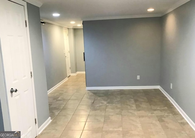 tiled empty room featuring ornamental molding