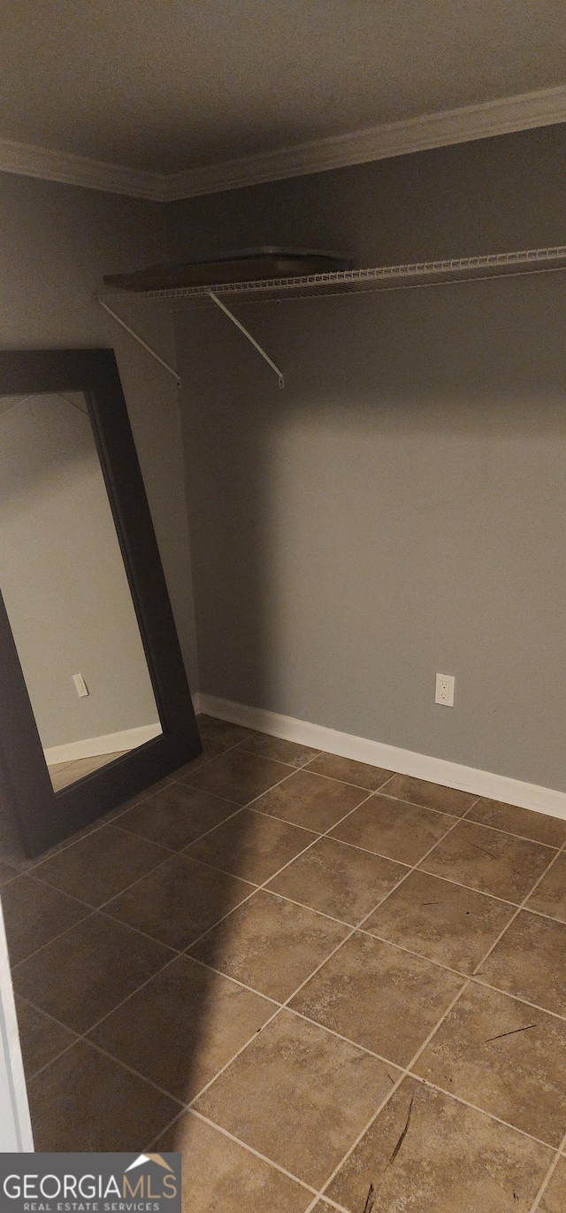 spacious closet featuring dark tile patterned flooring