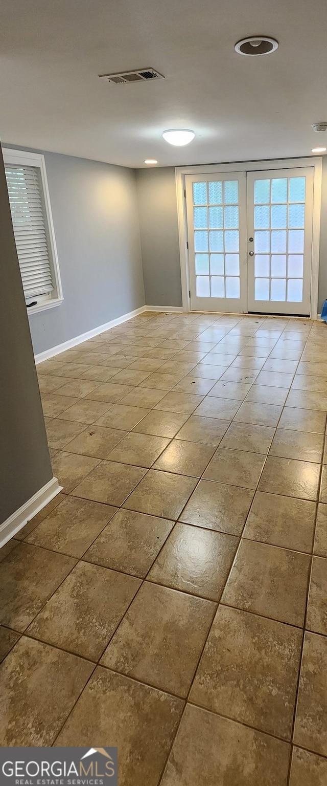 spare room featuring french doors