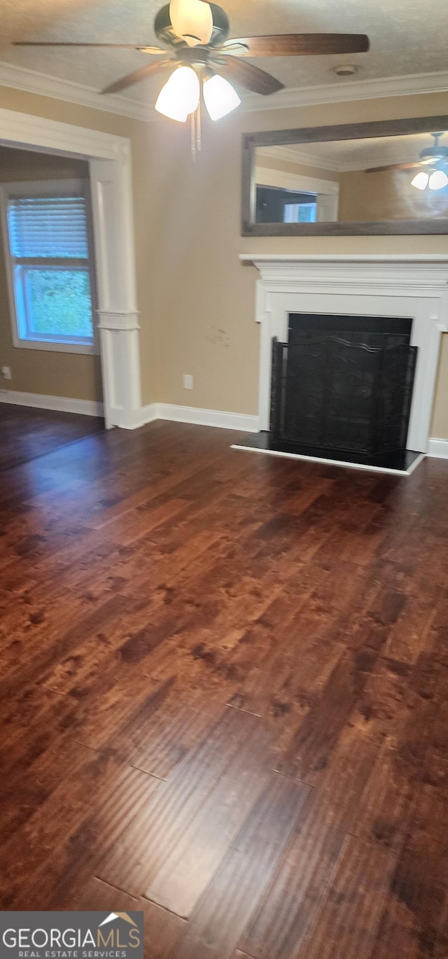 unfurnished living room with dark hardwood / wood-style floors and crown molding