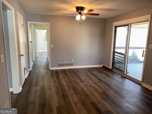 spare room featuring a textured ceiling, dark hardwood / wood-style floors, and ceiling fan