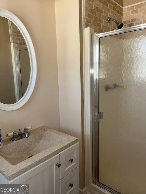 bathroom with vanity and a shower with shower door