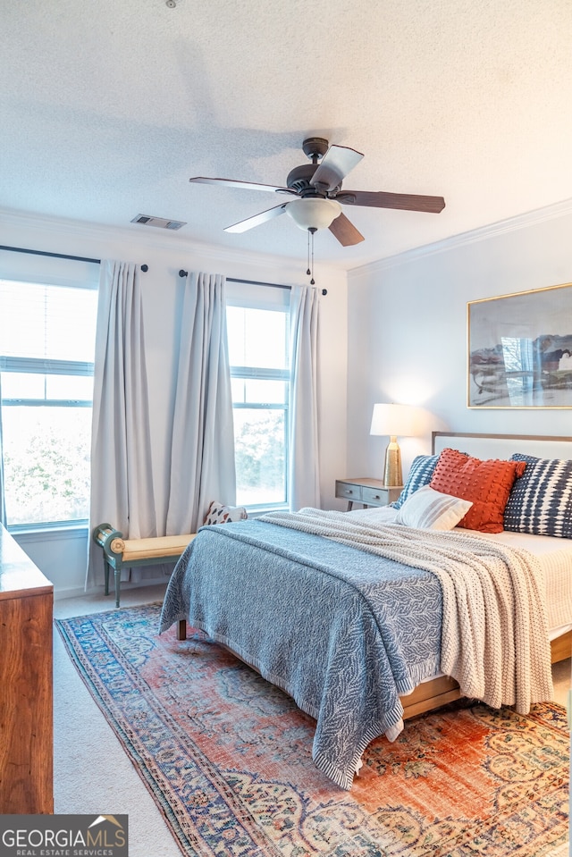 bedroom with a textured ceiling, ceiling fan, and crown molding