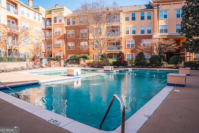 view of swimming pool with pool water feature