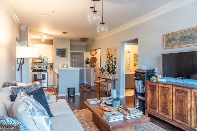 living room with dark hardwood / wood-style floors and ornamental molding