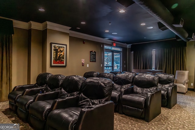 carpeted home theater room with crown molding