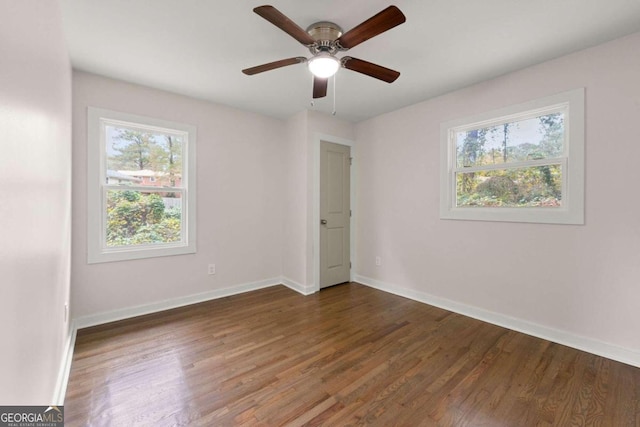 unfurnished room featuring ceiling fan and dark wood-type flooring