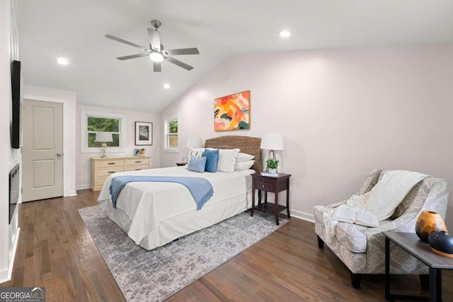 bedroom featuring ceiling fan, dark hardwood / wood-style floors, and vaulted ceiling