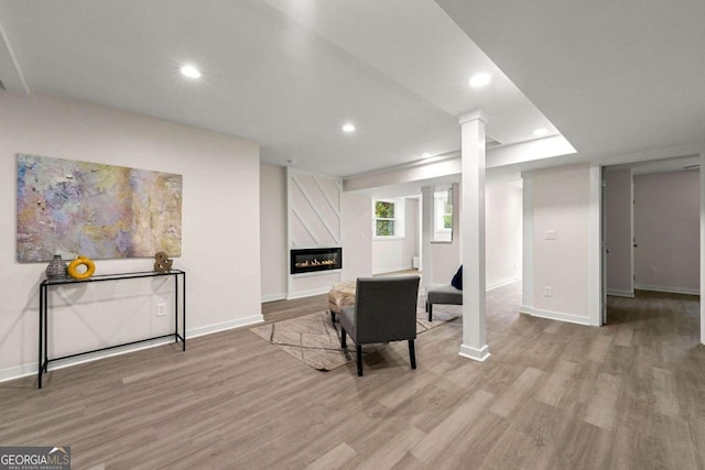 living room with a fireplace and light hardwood / wood-style floors