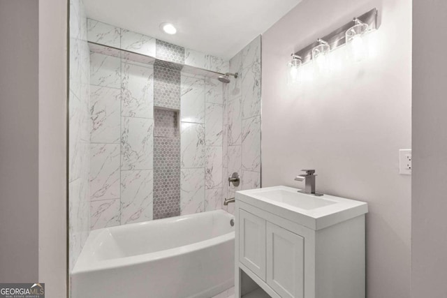 bathroom featuring tiled shower / bath combo and vanity