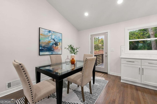 dining area with dark hardwood / wood-style floors and lofted ceiling