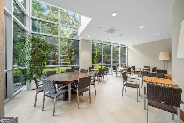 dining space featuring floor to ceiling windows and a healthy amount of sunlight