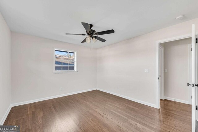 empty room featuring hardwood / wood-style flooring and ceiling fan