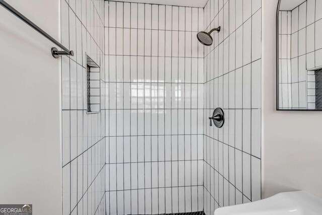 bathroom with tiled shower