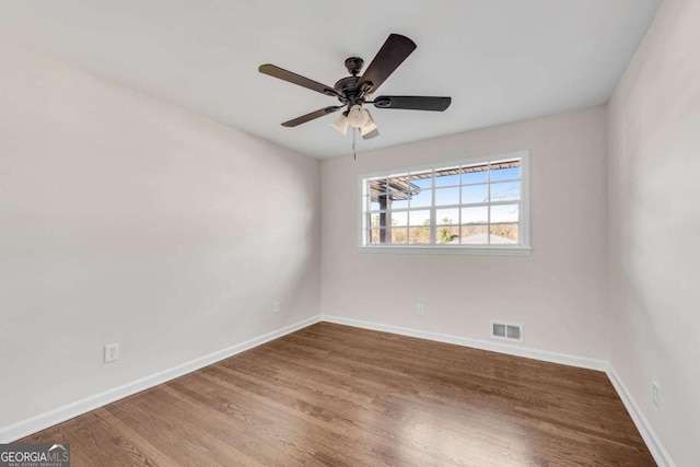 spare room with hardwood / wood-style floors and ceiling fan