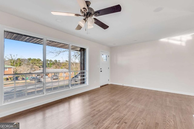 unfurnished room with ceiling fan and hardwood / wood-style floors