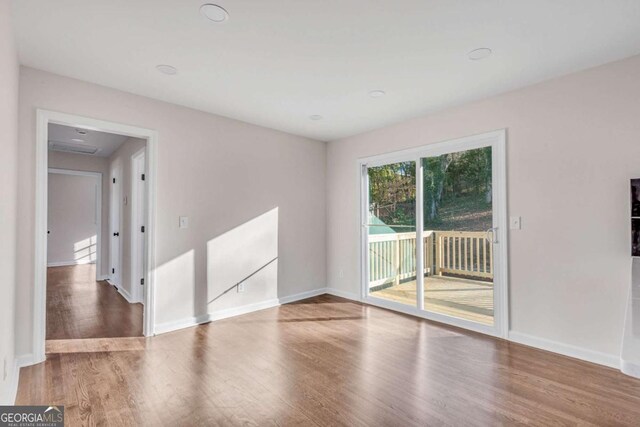 spare room with hardwood / wood-style floors