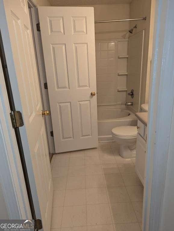 full bathroom featuring tile patterned flooring, vanity, toilet, and shower / bathing tub combination