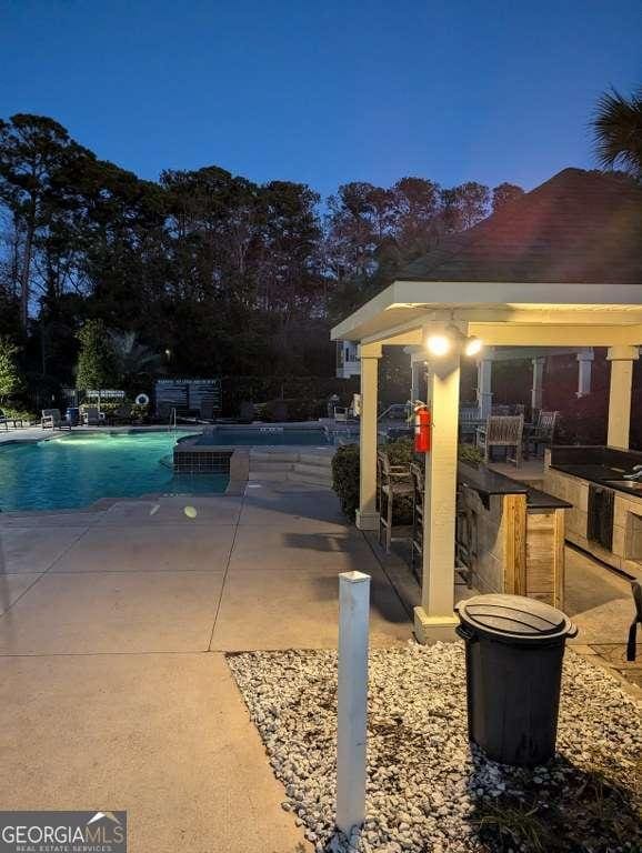 view of swimming pool with a patio area and an outdoor bar