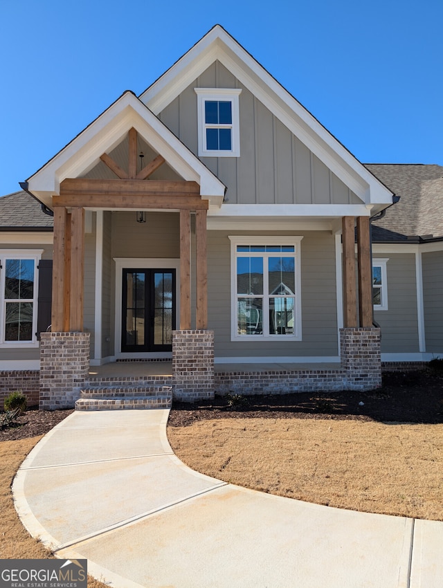 view of front facade with covered porch and french doors