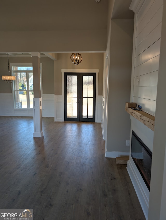 foyer entrance featuring french doors, dark hardwood / wood-style flooring, and a notable chandelier