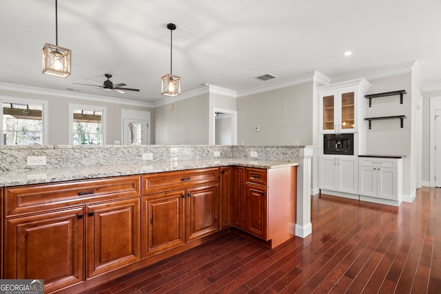 kitchen with ceiling fan, light stone countertops, decorative light fixtures, and ornamental molding