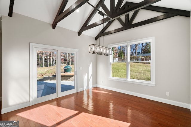 unfurnished dining area with beamed ceiling, high vaulted ceiling, and hardwood / wood-style flooring