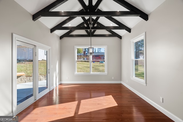 unfurnished dining area featuring wood-type flooring, lofted ceiling with beams, an inviting chandelier, and a wealth of natural light