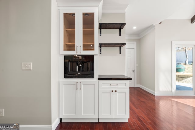 bar with white cabinets, oven, dark hardwood / wood-style floors, and crown molding