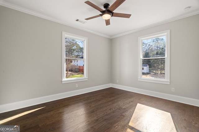 unfurnished room featuring dark hardwood / wood-style floors, a healthy amount of sunlight, and ornamental molding