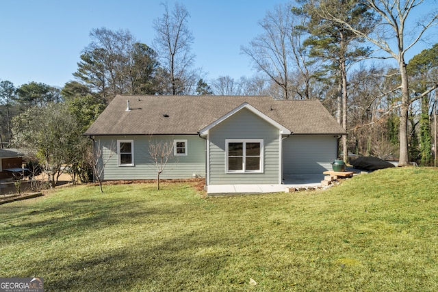 rear view of house with a patio area and a yard