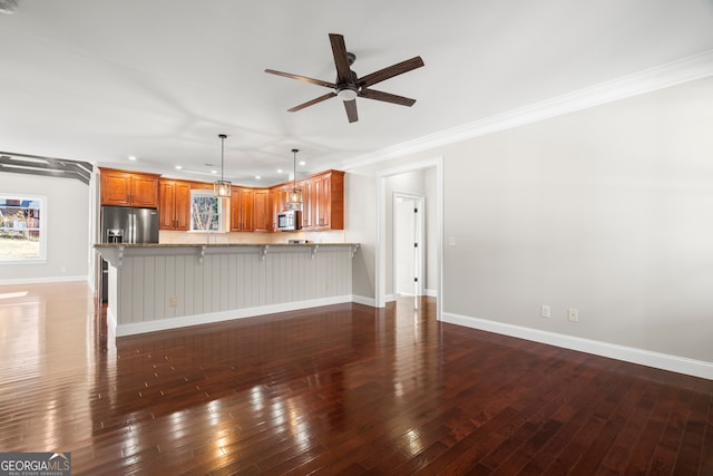 unfurnished living room featuring ceiling fan, dark hardwood / wood-style floors, and ornamental molding