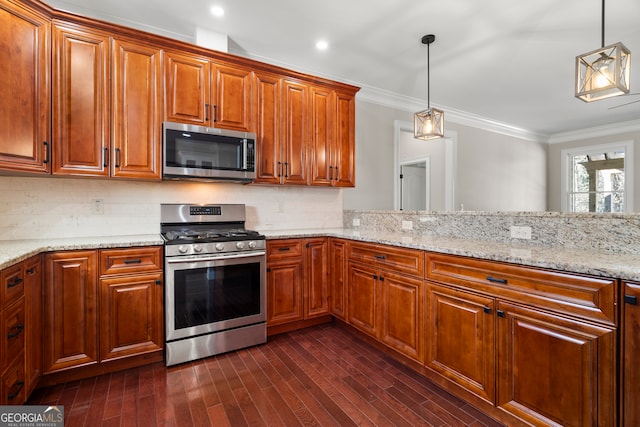 kitchen featuring pendant lighting, light stone counters, backsplash, and appliances with stainless steel finishes