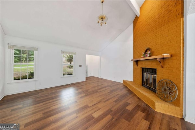 unfurnished living room featuring beam ceiling, dark wood-type flooring, a fireplace, and high vaulted ceiling