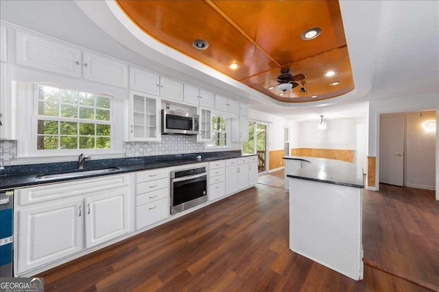 kitchen with white cabinetry, sink, stainless steel appliances, and a raised ceiling