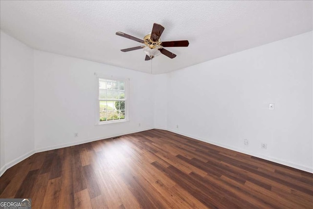 spare room featuring ceiling fan, dark hardwood / wood-style floors, and a textured ceiling